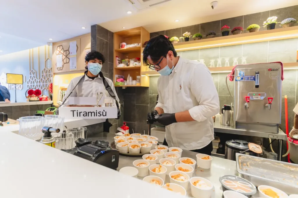 Tiramisu being prepared at the dessert counter