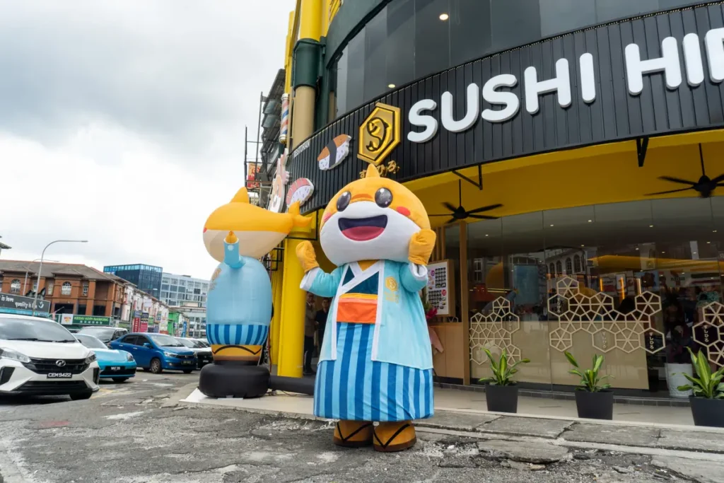 Hiro Boy welcoming guests outside a Sushi Hiro outlet